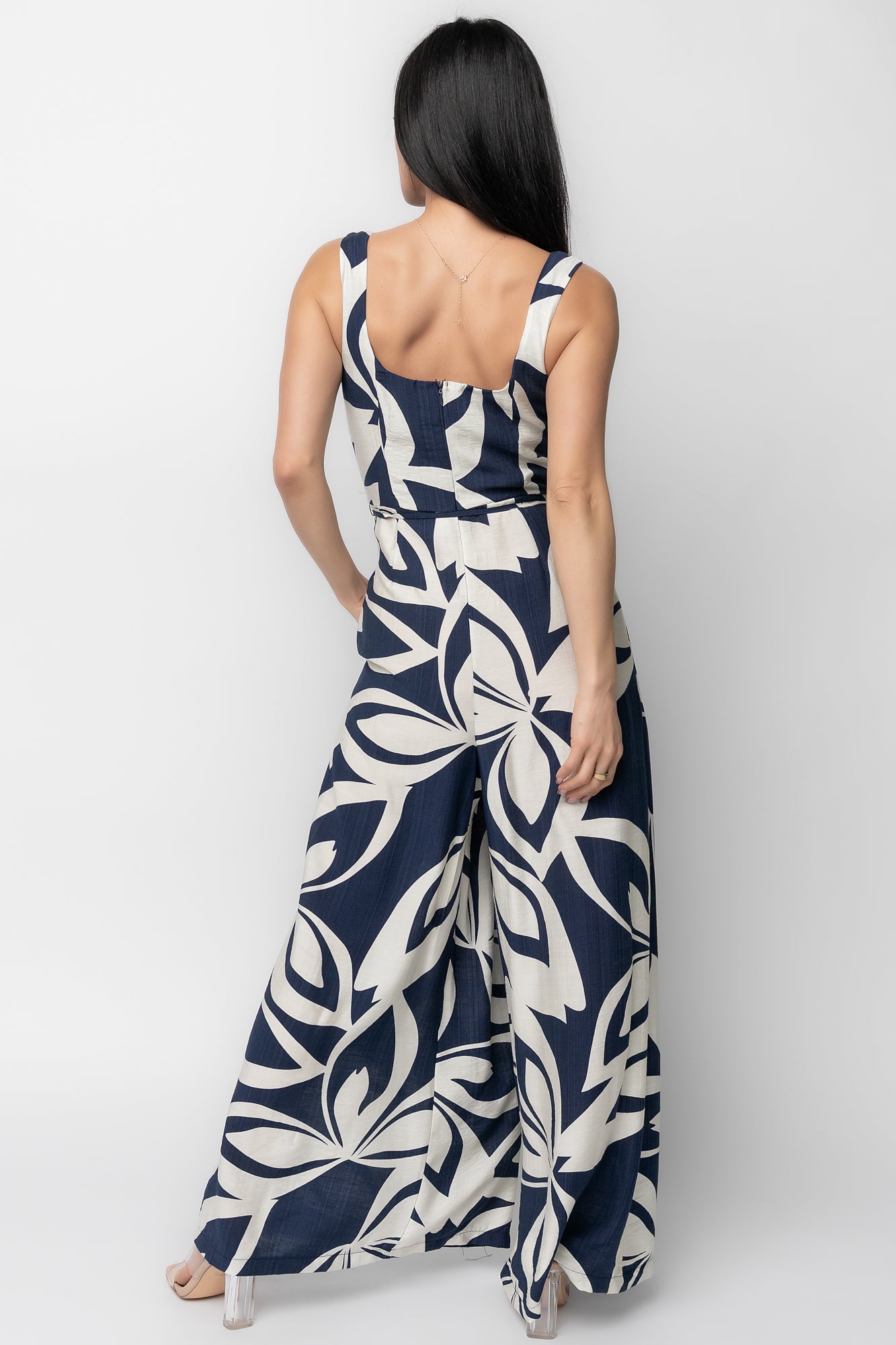 Detail shot of navy abstract print and pleating on Manuela jumpsuit fabric, showing texture and the removable self waist tie feature.