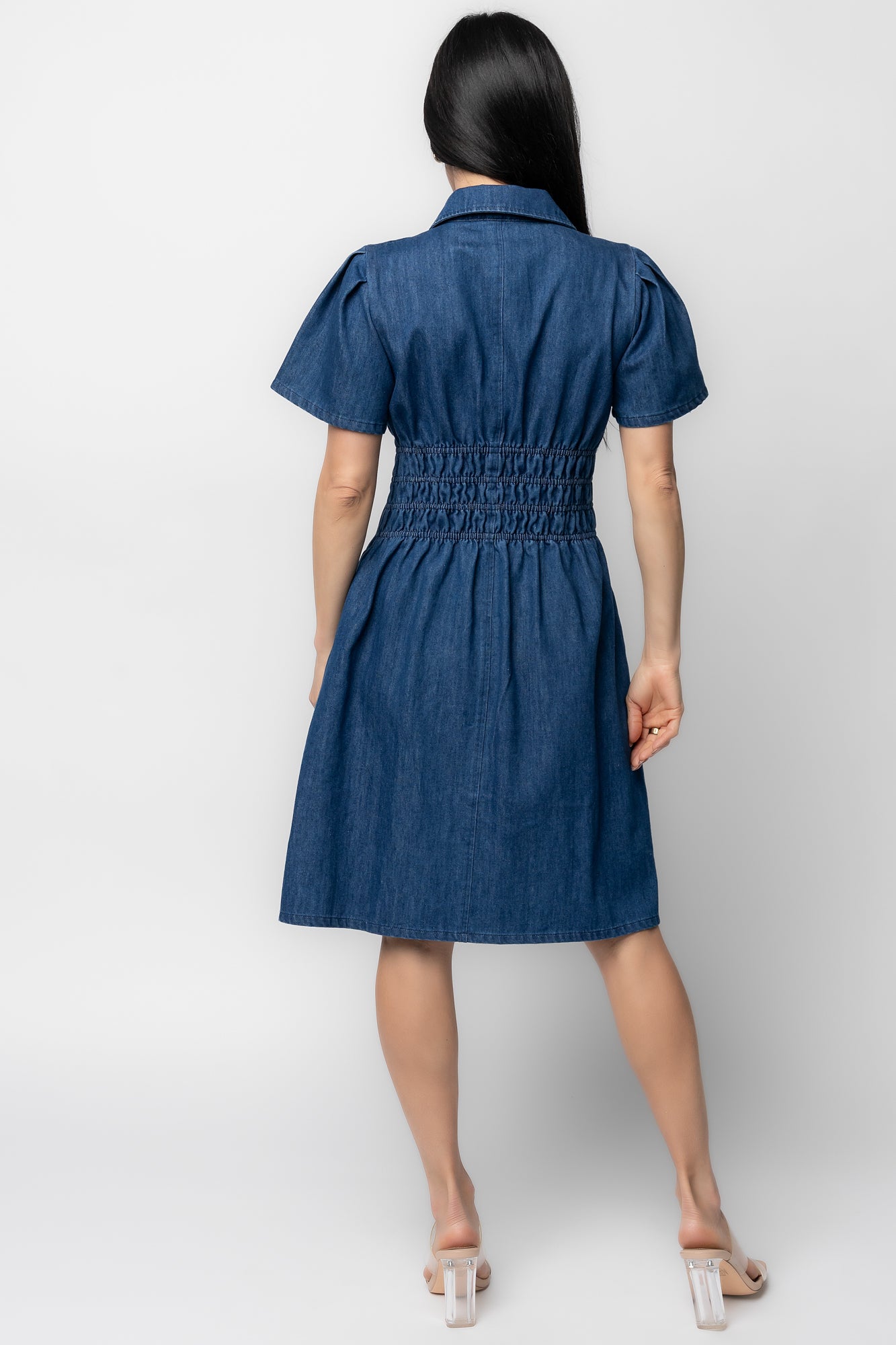 Back view highlighting the elastic back waist and clean unlined interior of the Coco Denim Short Dress, ideal for everyday wear and layering.