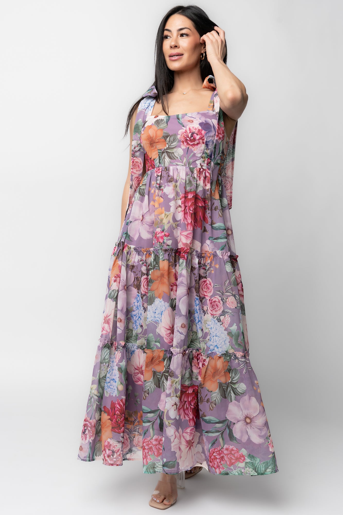 Front view of Anita Maxi Dress in lavender multi floral print on model; square neckline, smocked bodice, and flowing tiered chiffon skirt showcasing full length.