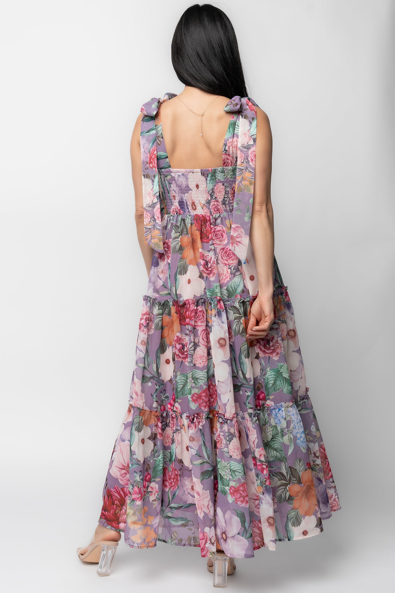 Side view of Anita Maxi Dress in lavender multi floral illustrating ruffled tiers, chiffon overlay movement and the dress's maxi length.