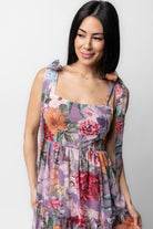 Back view of Anita Maxi Dress showing smocked back, adjustable self-tie straps and lavender multi floral print on a flowing chiffon maxi silhouette.