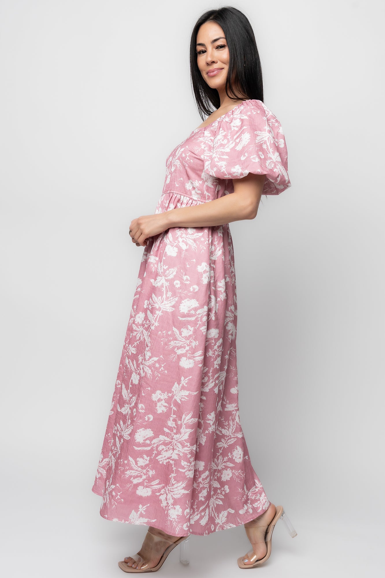 Styled outfit shot of pink floral Graceland Maxi Dress paired with neutral sandals to show length and movement of skirt.