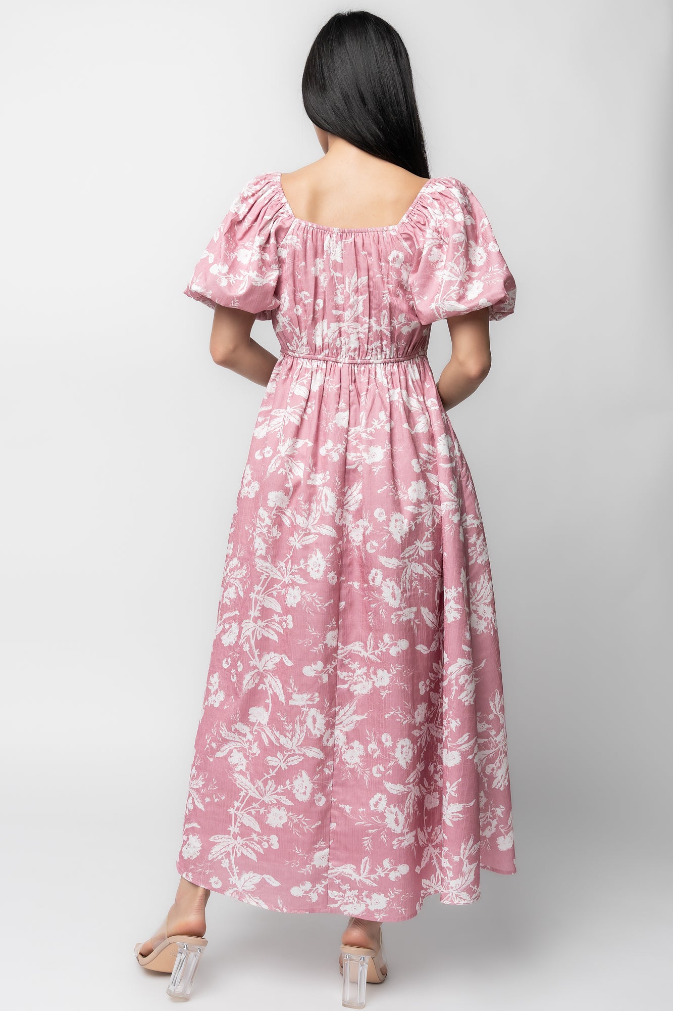 Back view showing bloused back, stretch elastic waist detail, and full A-line skirt in pink with white florals.