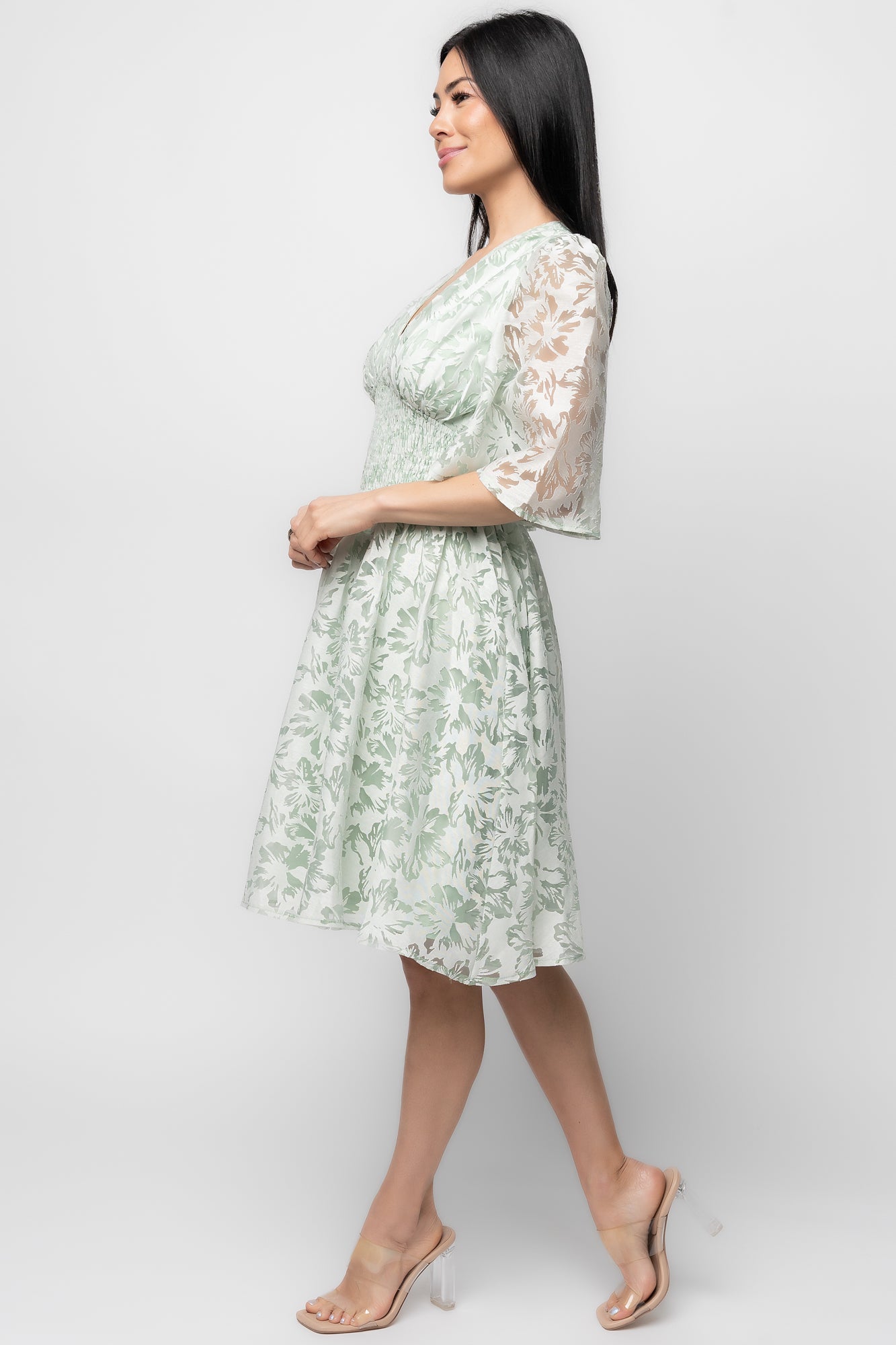 Back view of the Bonnie Short Dress showing back zipper with smocking and the fitted smocked empire waist in light sage floral.