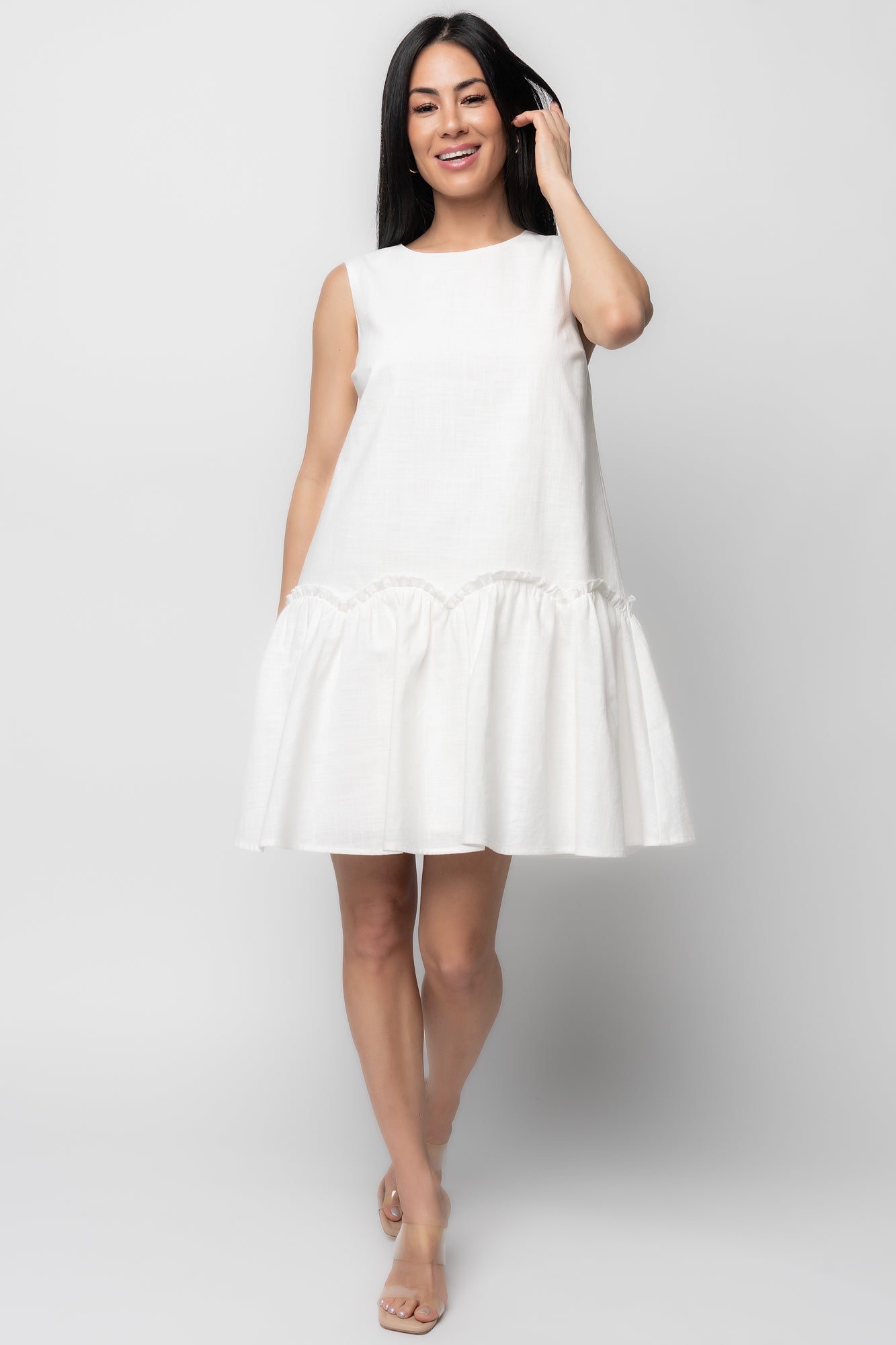 Front view of Paulina Short Dress in off-white textured cotton, showing round neckline, tank sleeves, and scalloped ruffle tier for feminine movement.