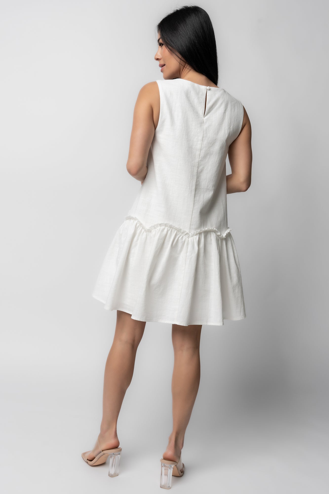 Back view of Paulina Short Dress in off-white, showing keyhole closure with button at nape and smooth, fully lined back panel for structure.