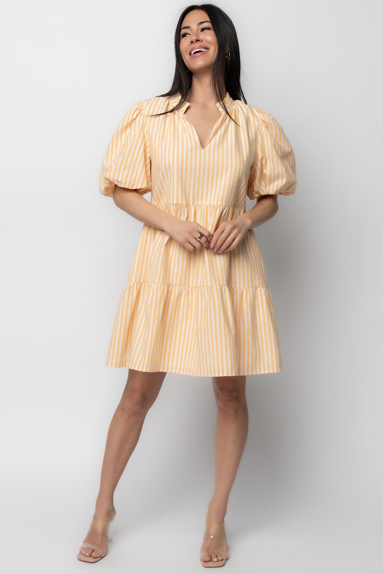 Front view of the Sadie Short Dress in Creamsicle with off-white and soft-orange stripes, ruffled V-neckline and short balloon sleeves.
