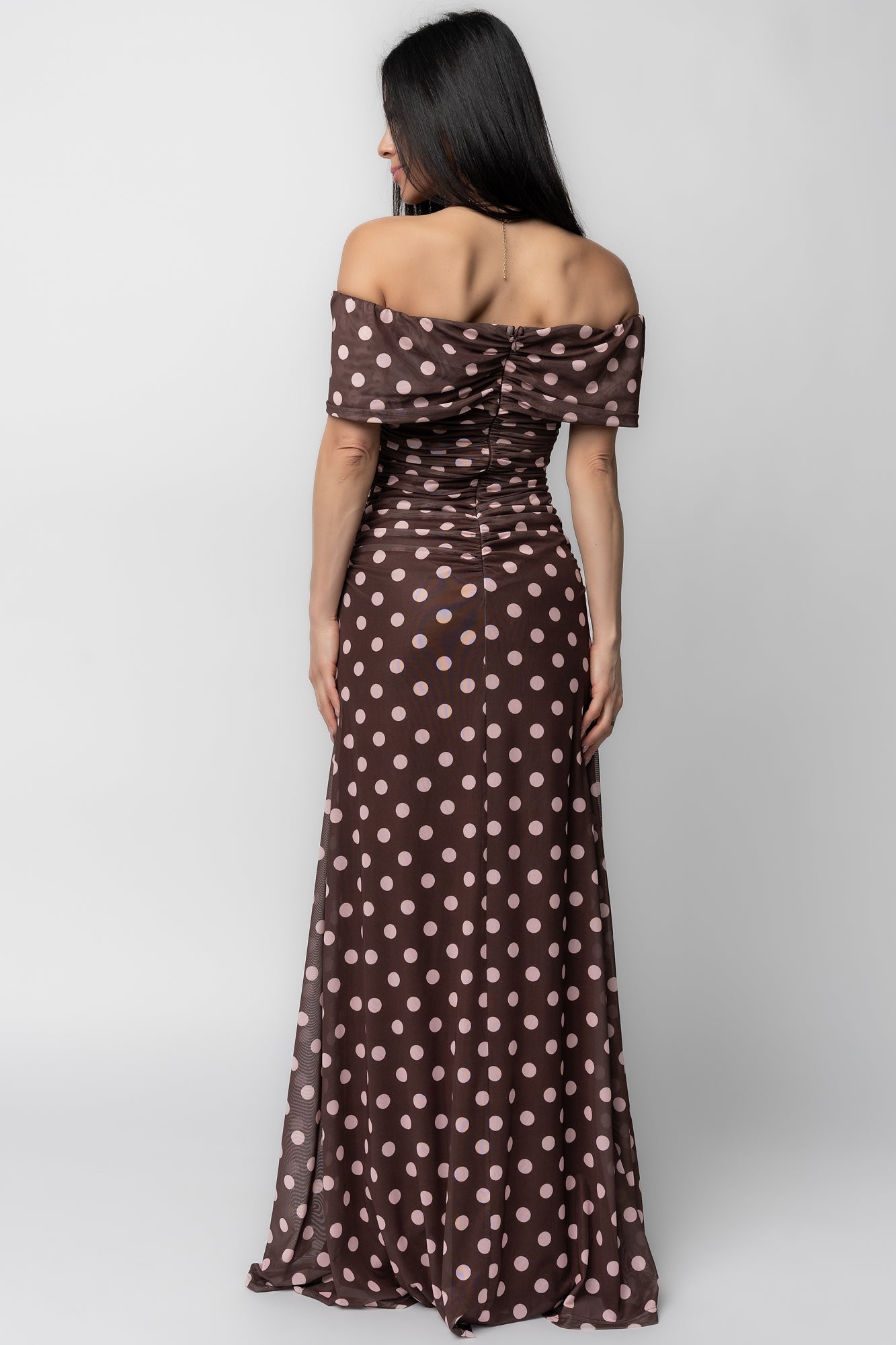 Model walking in Maisie off-shoulder maxi dress—fabric sways to show drape, length, and polish for special occasions.