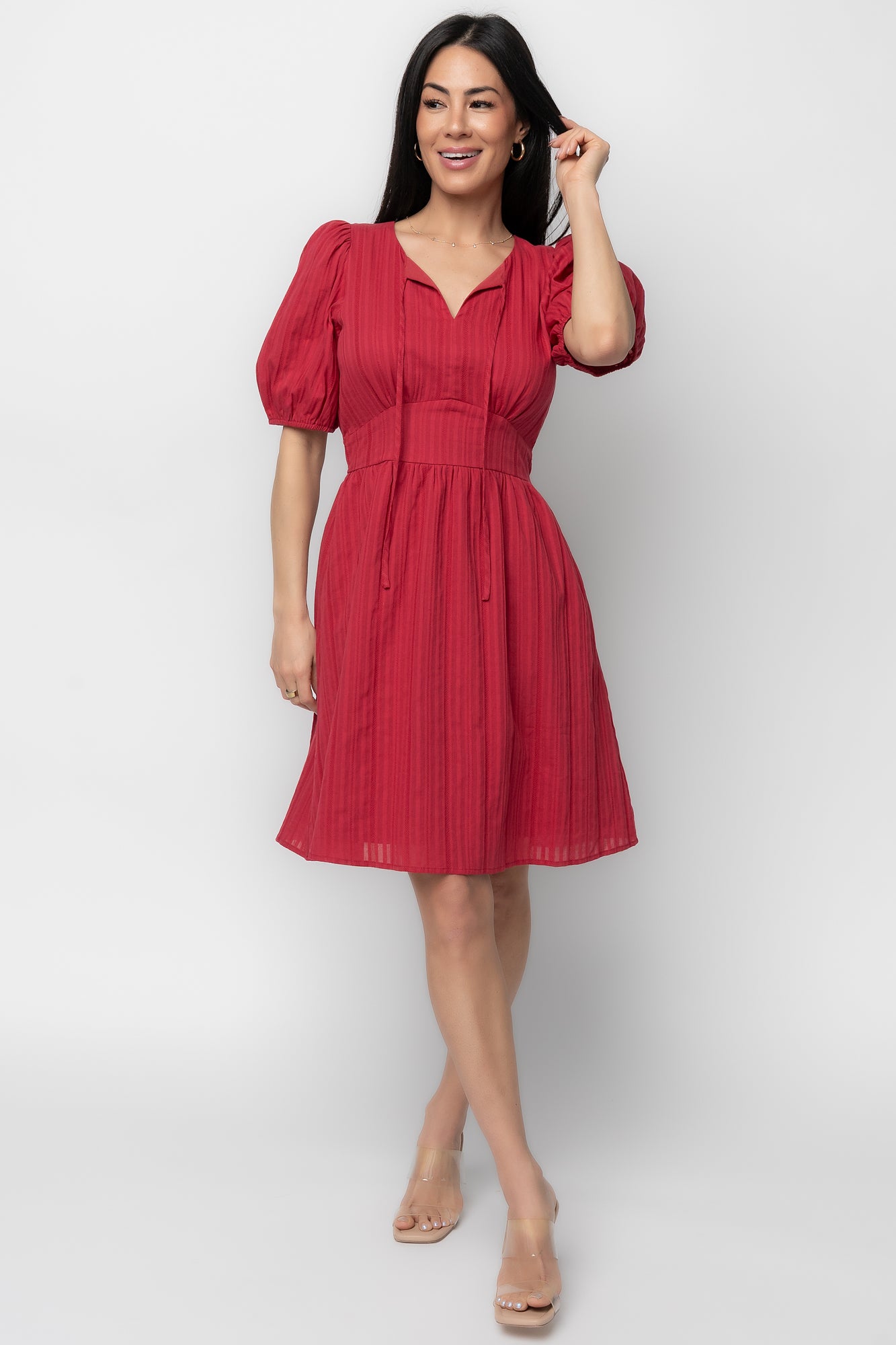 Model wearing Hayley Short Dress in dusty red, front view showing V-neck, short sleeves, mini hem, and hidden side pockets.