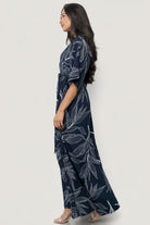 Styled look of Kalea Maxi Dress on model at an event setting, highlighting botanical print, kimono sleeves and flattering maxi silhouette.