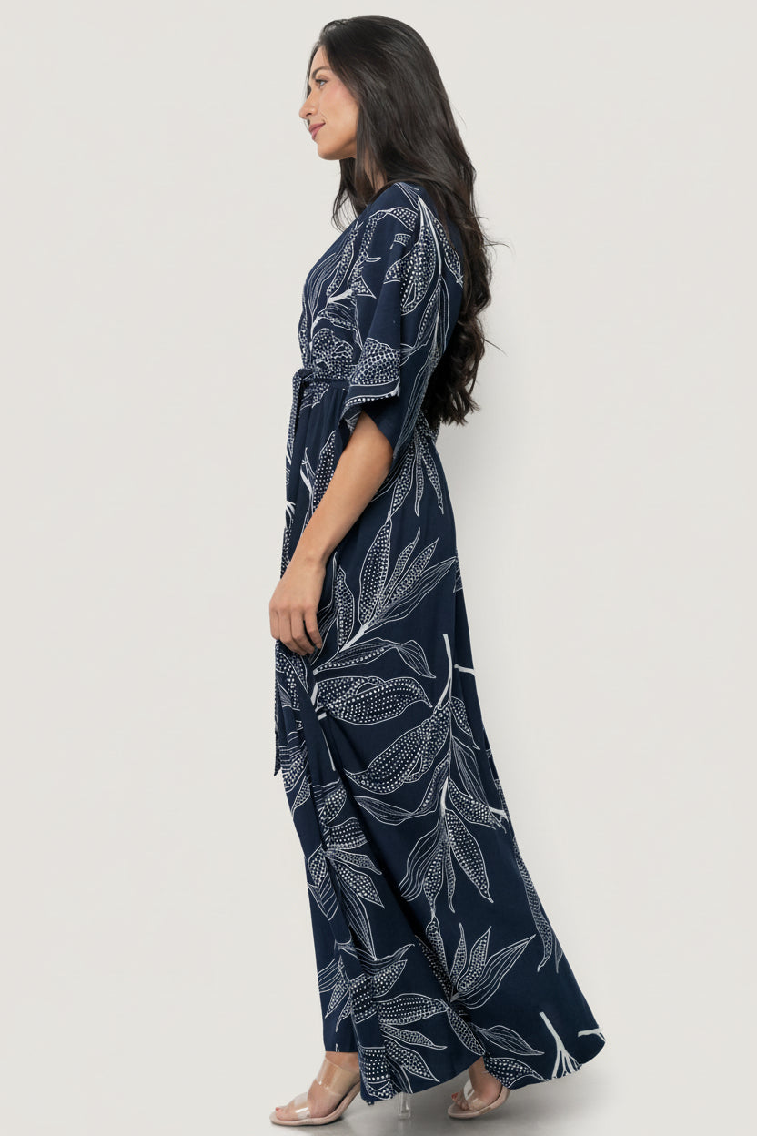 Styled look of Kalea Maxi Dress on model at an event setting, highlighting botanical print, kimono sleeves and flattering maxi silhouette.