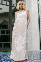 Close-up of neckline and shoulder of the Aurelia Dress in natural white print, emphasizing cinched halter detail.