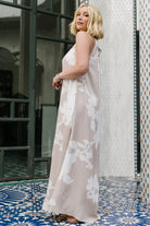 Full-length shot of the Aurelia Halter Maxi Dress in natural white print, highlighting unlined maxi skirt and column silhouette.