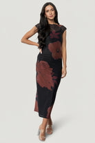 Front view of Daniela mesh midi dress in black with deep maroon floral print, showing included ribbed slip and fitted silhouette.