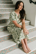Styled outfit image of Aventura Midi Dress paired with sandals, showing full length and breezy movement of the tiered skirt.