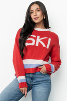 Close-up of knit fabric and graphic detail on the red multi Gilli ski sweater showing stitch texture and light pink and periwinkle accents.