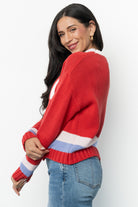 Side and back view of the red multi Gilli ski sweater highlighting length, sleeve drop, and overall fit on the body for styling reference.