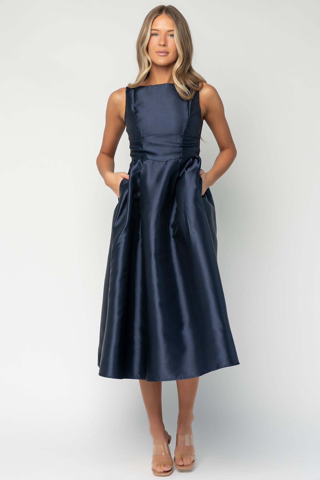 Model wearing Chandra navy midi dress styled with tank sleeves and boat neckline; shows natural drape and length.