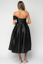 Back view of Amani black midi dress showing the back zipper closure, basque waist shaping, and the fully lined interior.
