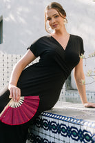 Styled shot of the Annaeli black maxi dress paired with accessories to demonstrate versatile outfit options for formal or casual occasions.