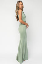 Full-length view of Avalon Maxi Dress on a hanger, dusty sage color, boat neckline, fitted bodice, and flowing maxi skirt for display.