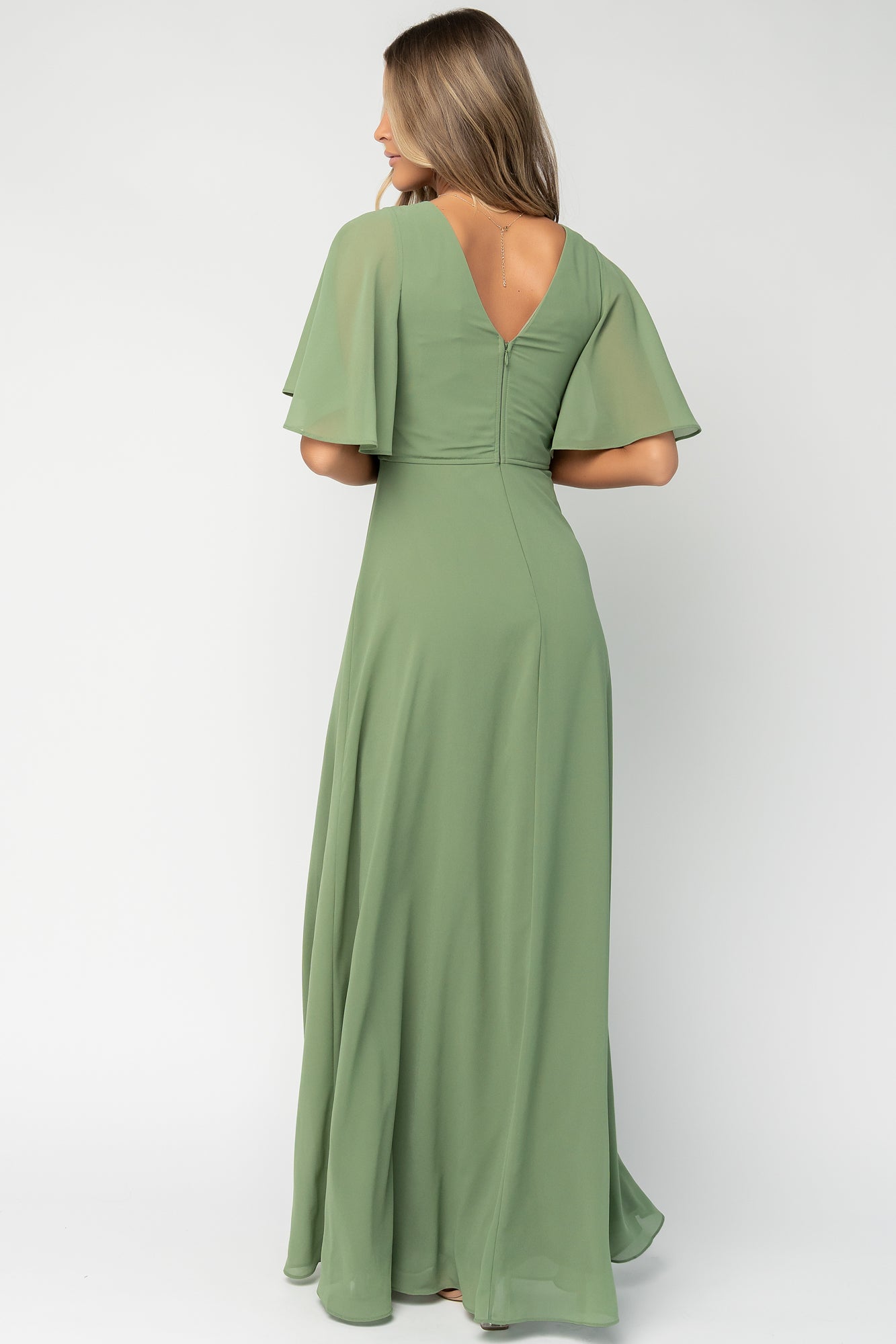 Close-up of bodice with seams and defined waist of the olive Valetta dress, displaying fine chiffon layering and tailoring.