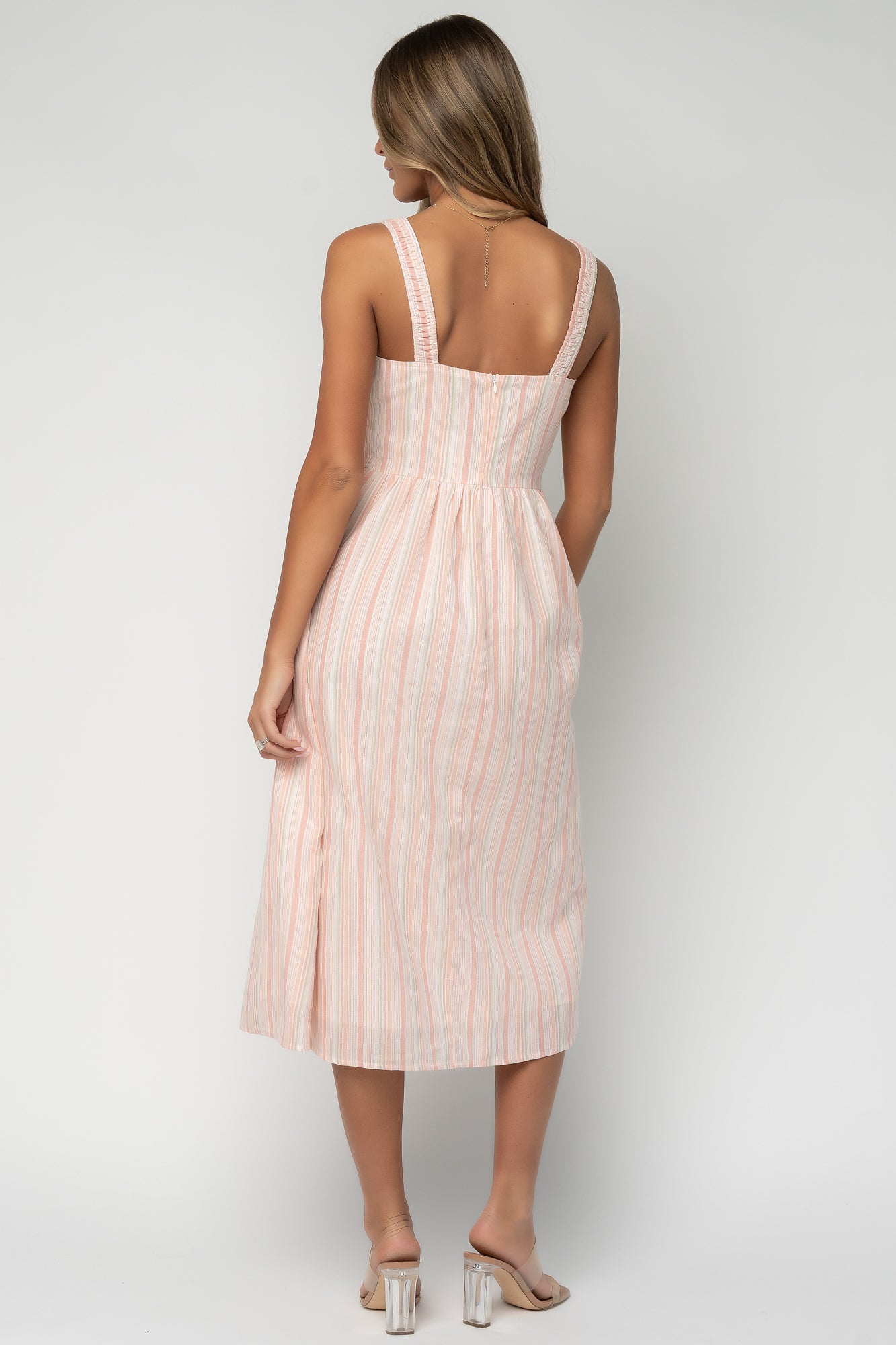 Styled look of Melina Midi Dress paired with neutral sandals, illustrating the dress's relaxed silhouette, midi hem and suitability for outdoor events and wedding guest wear.