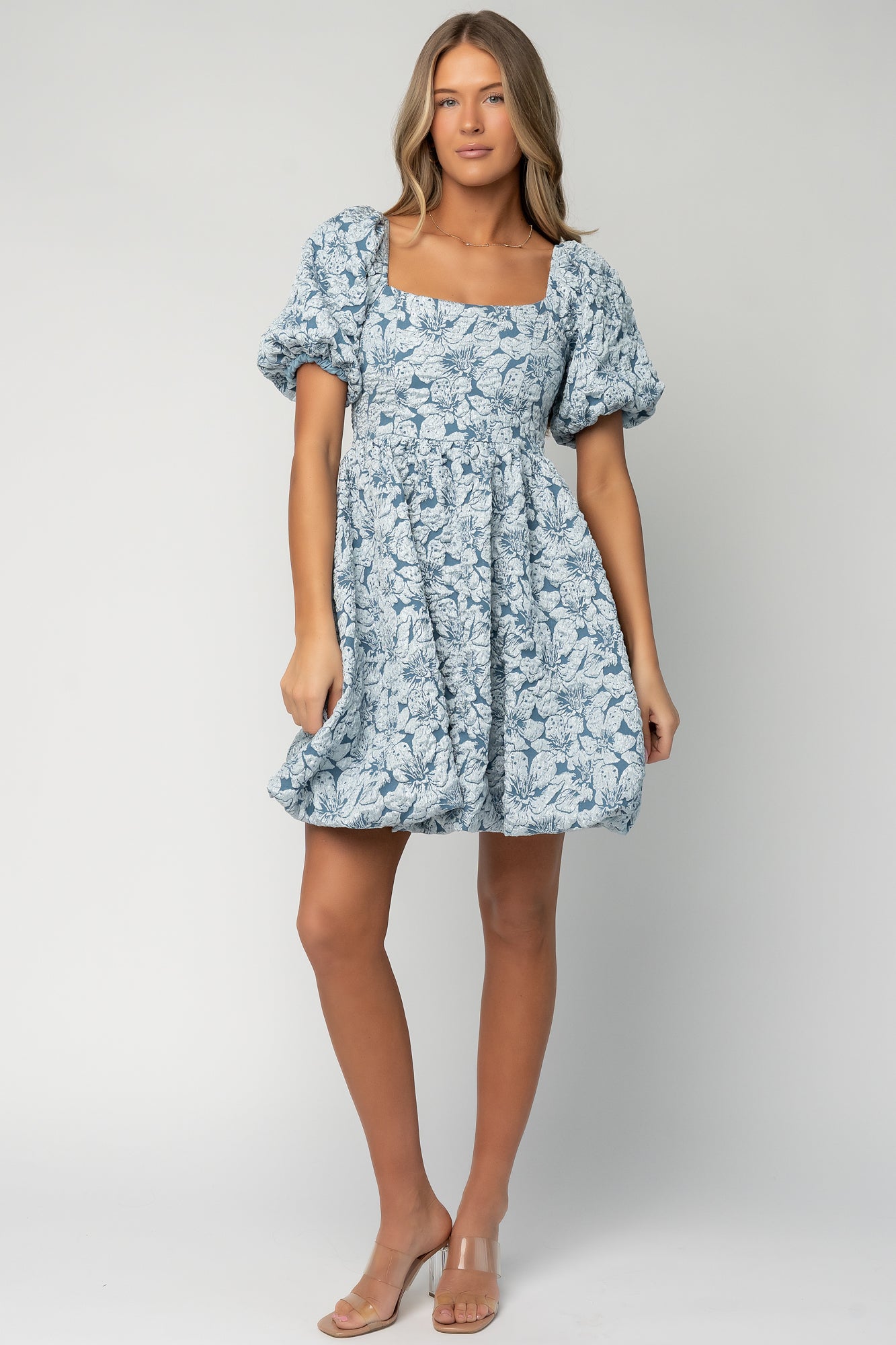 Front view of Dusty Blue Enchanted Jacquard Dress on model showing square neckline, short puffed sleeves, and A-line silhouette.