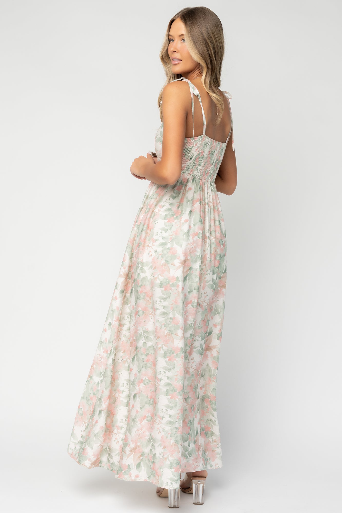 Close-up of dress bodice showing smocked back panel and adjustable tank strap hardware, illustrating fit and fabric texture.