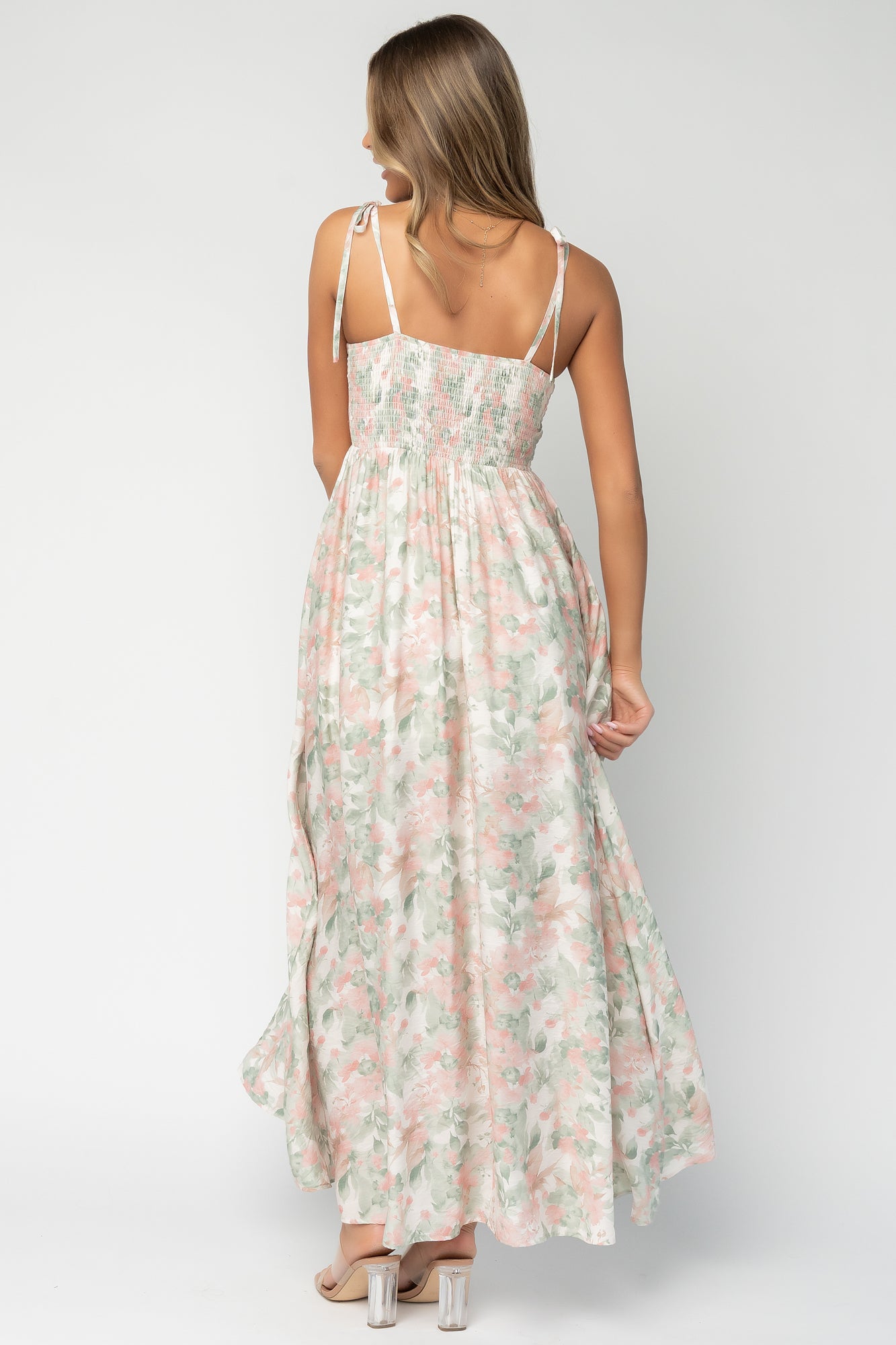 Side view of Elton Maxi Dress worn by model, revealing hidden side pocket placement and elegant silhouette with mid-thigh lining coverage.