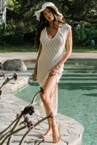 Lifestyle image of Calypso cover-up styled with swimwear and sandals, illustrating its lightweight layering and beach-ready versatility.