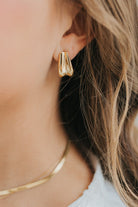 Front view of The Sicily Hoop pair in gold plating, highlighting the sculptural folded-metal shape and polished, tarnish-resistant finish.