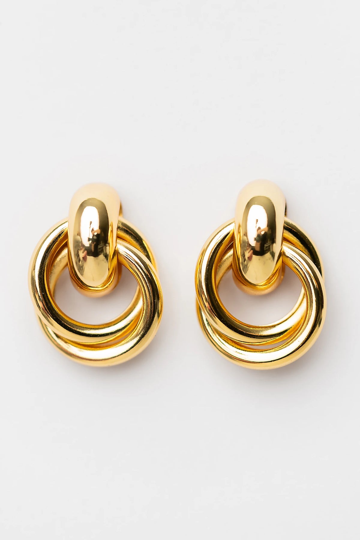 Abby Statement Earrings in Gold with polished gold-tone finish, layered circular design, and sculptural silhouette.