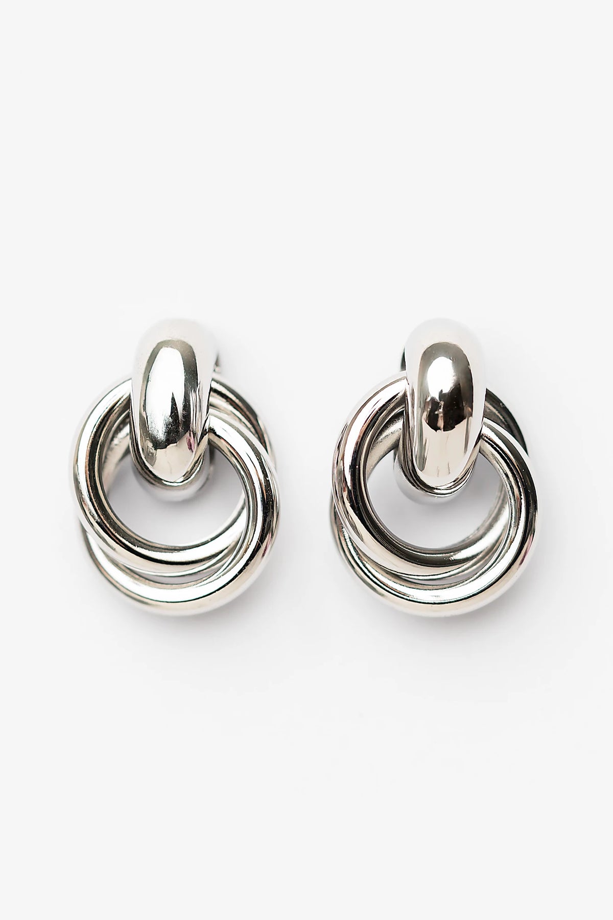 Abby Statement Earrings in Silver with polished silver-tone finish, layered circular design, and sculptural silhouette.