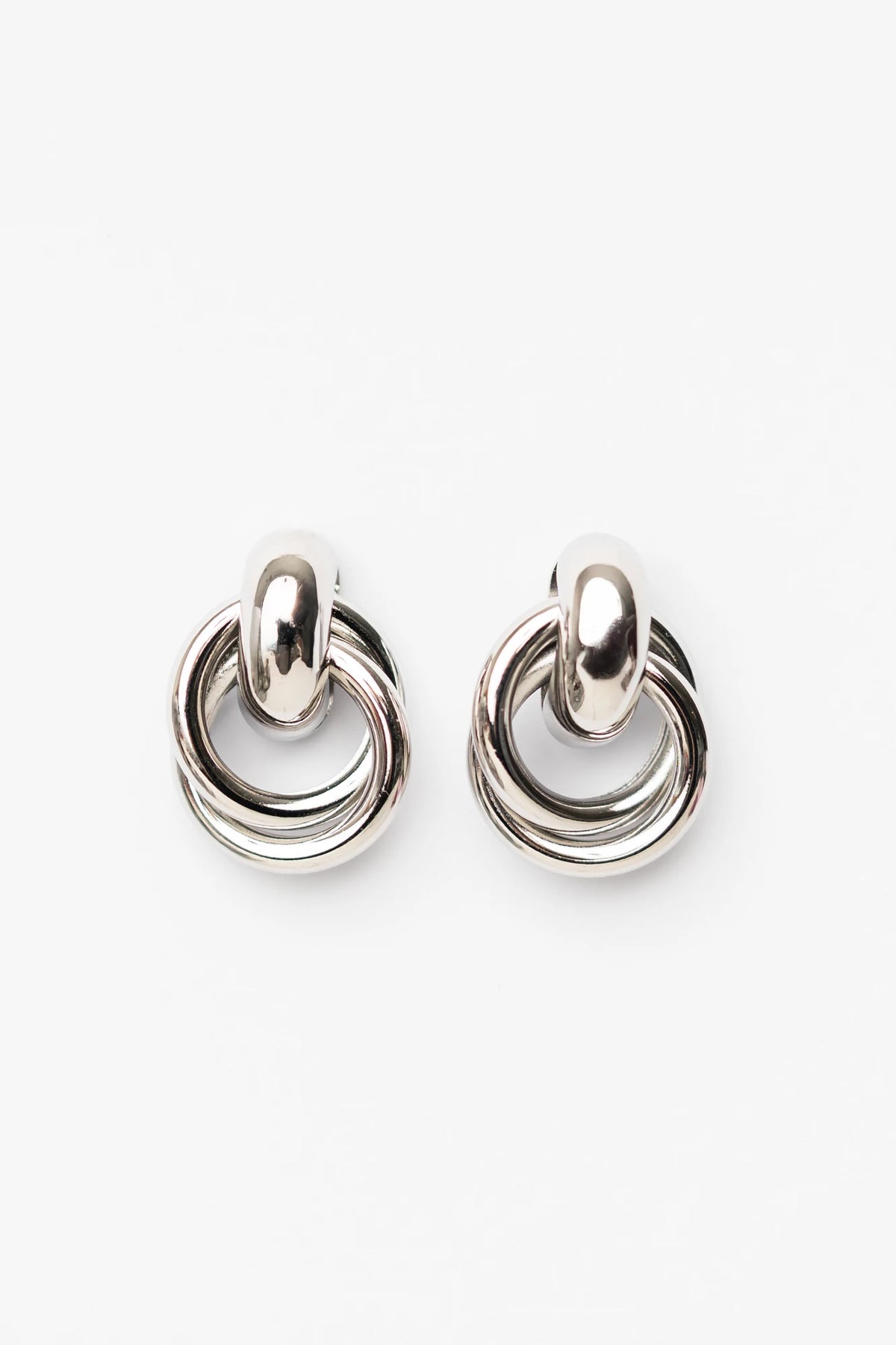Abby Statement Earrings in Silver with polished silver-tone finish, layered circular design, and sculptural silhouette.