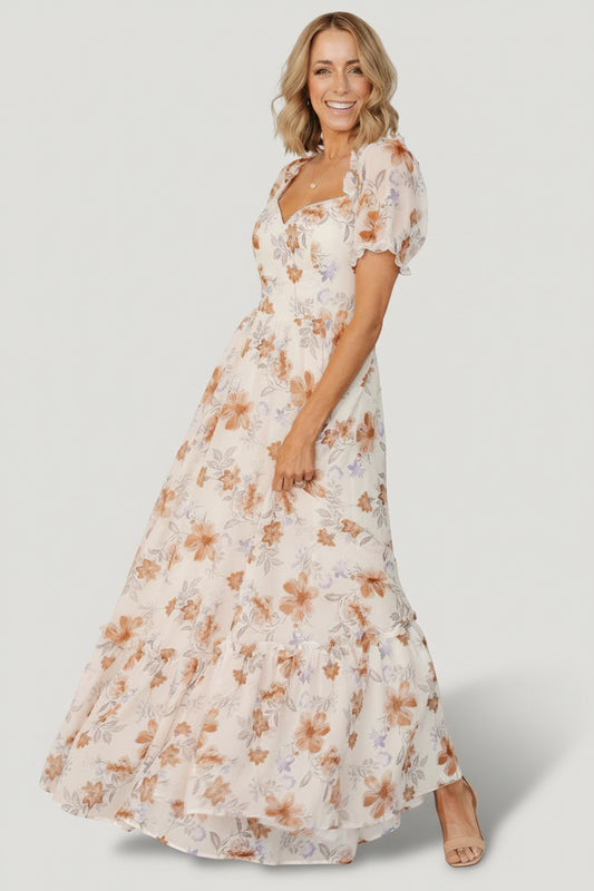 Cream floral sweetheart maxi dress - front view showing ruffle neckline, smocked back, puff sleeves, and tiered lined skirt.
