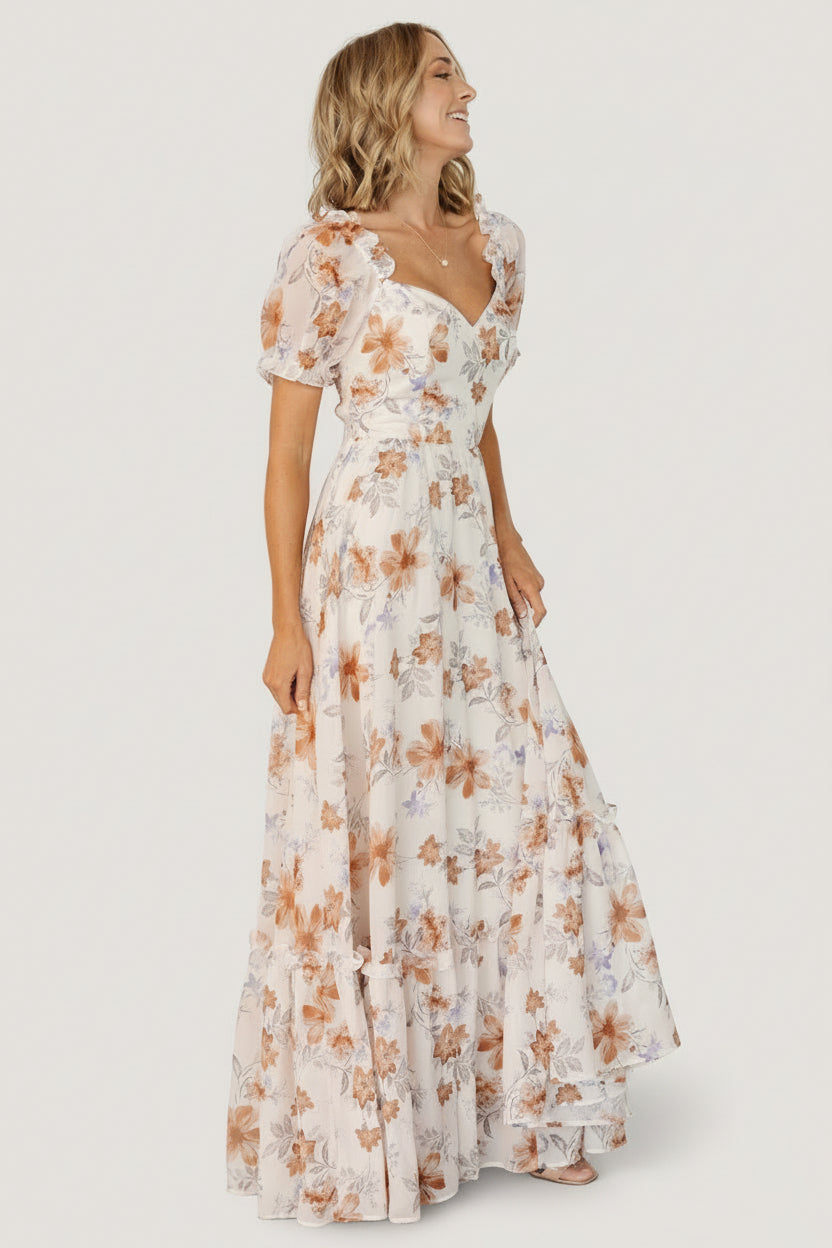 Close-up of short unlined puff sleeve with elastic and ruffle detail on cream floral sweetheart maxi dress.