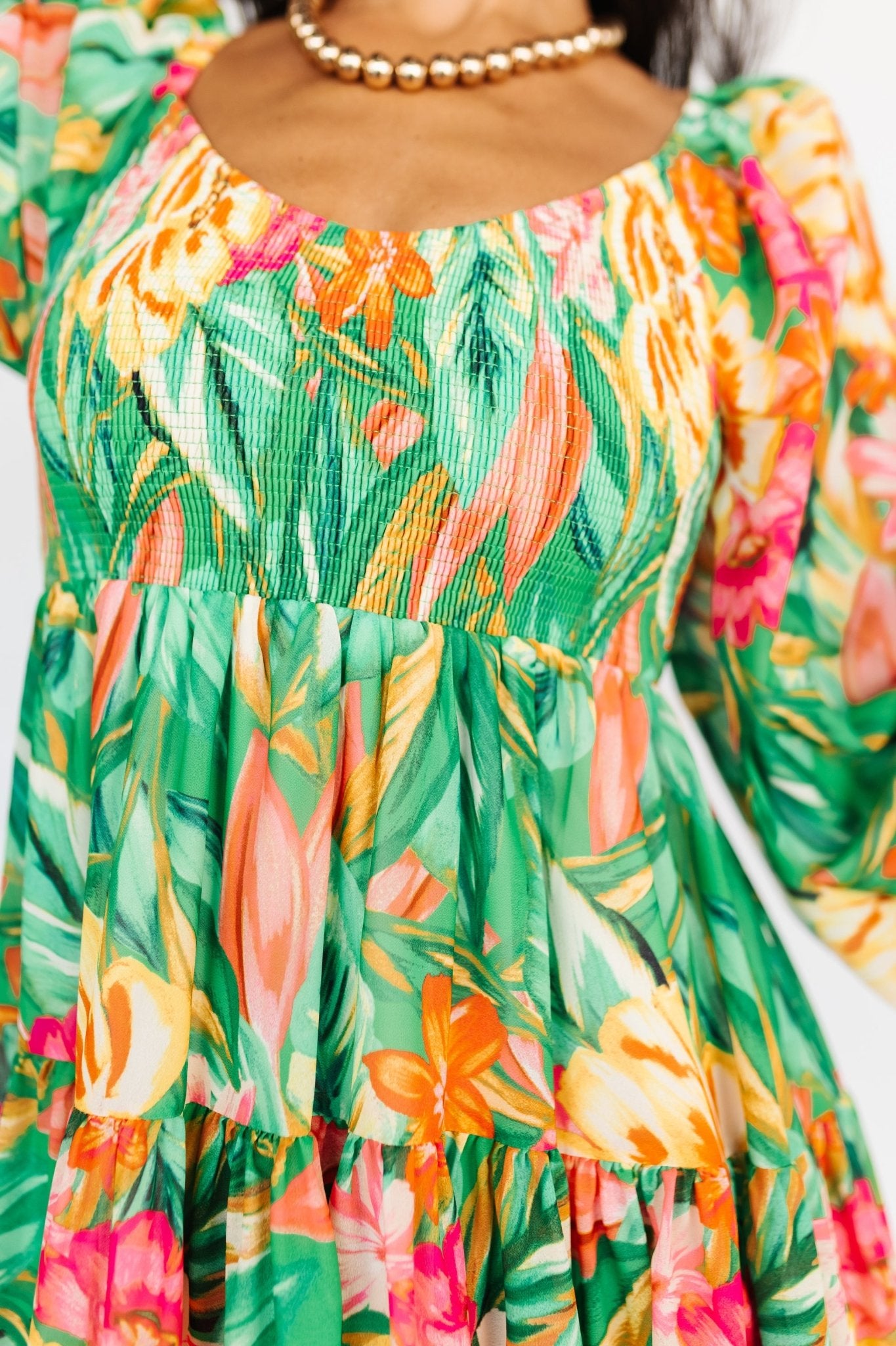 Detail shot of sleeve cuff showing elastic finish on long sheer sleeve of the green multi-print chiffon dress.