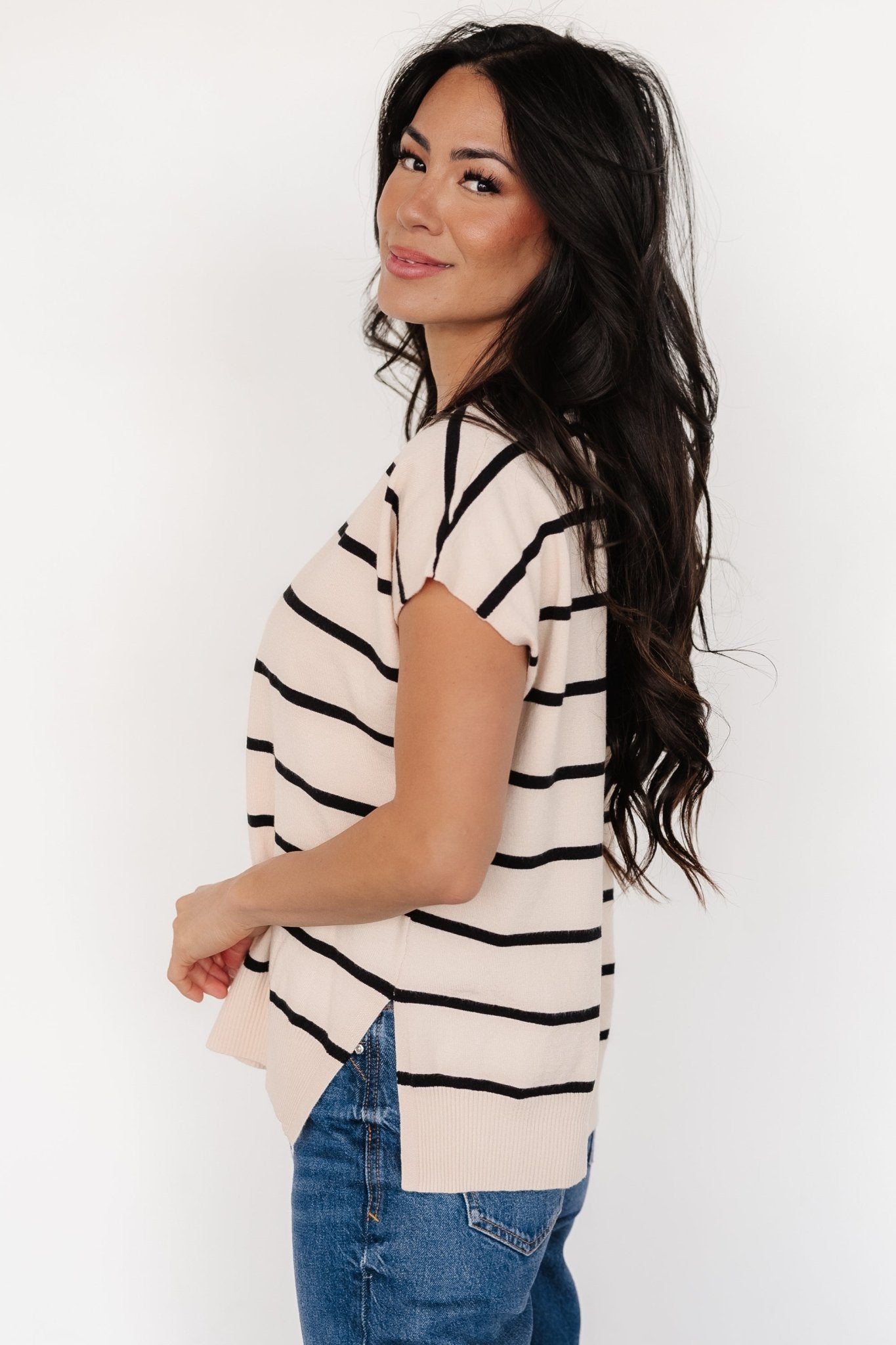 Close-up of Ada Dolman Top knit fabric showing natural ground with black horizontal stripes, ribbed hem and soft textured knit composition.