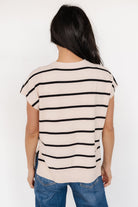 Model wearing Ada Dolman Top in natural and black stripes paired with casual pants, showing overall drape, short dolman sleeves and split side hem.