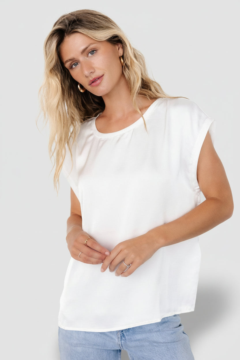 Front view of white Adina satin-look top on model showing round neckline, low armholes and oversized relaxed drape, lightweight fabric.