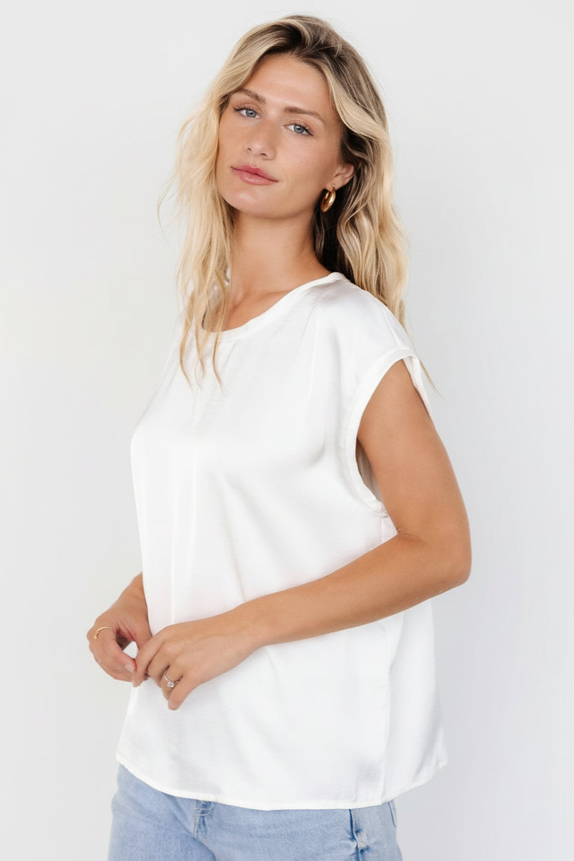 Model wearing white Adina Top paired with trousers, showing full-length view, relaxed fit and how the top tucks at the waist.