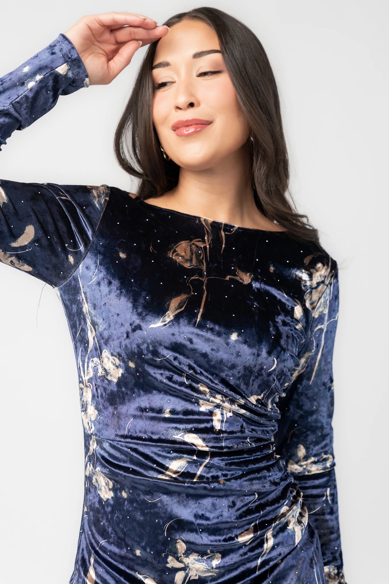 Afterglow Velvet Midi Dress in Navy + Gold with metallic florals, boat neckline, long sleeves, and side draping.