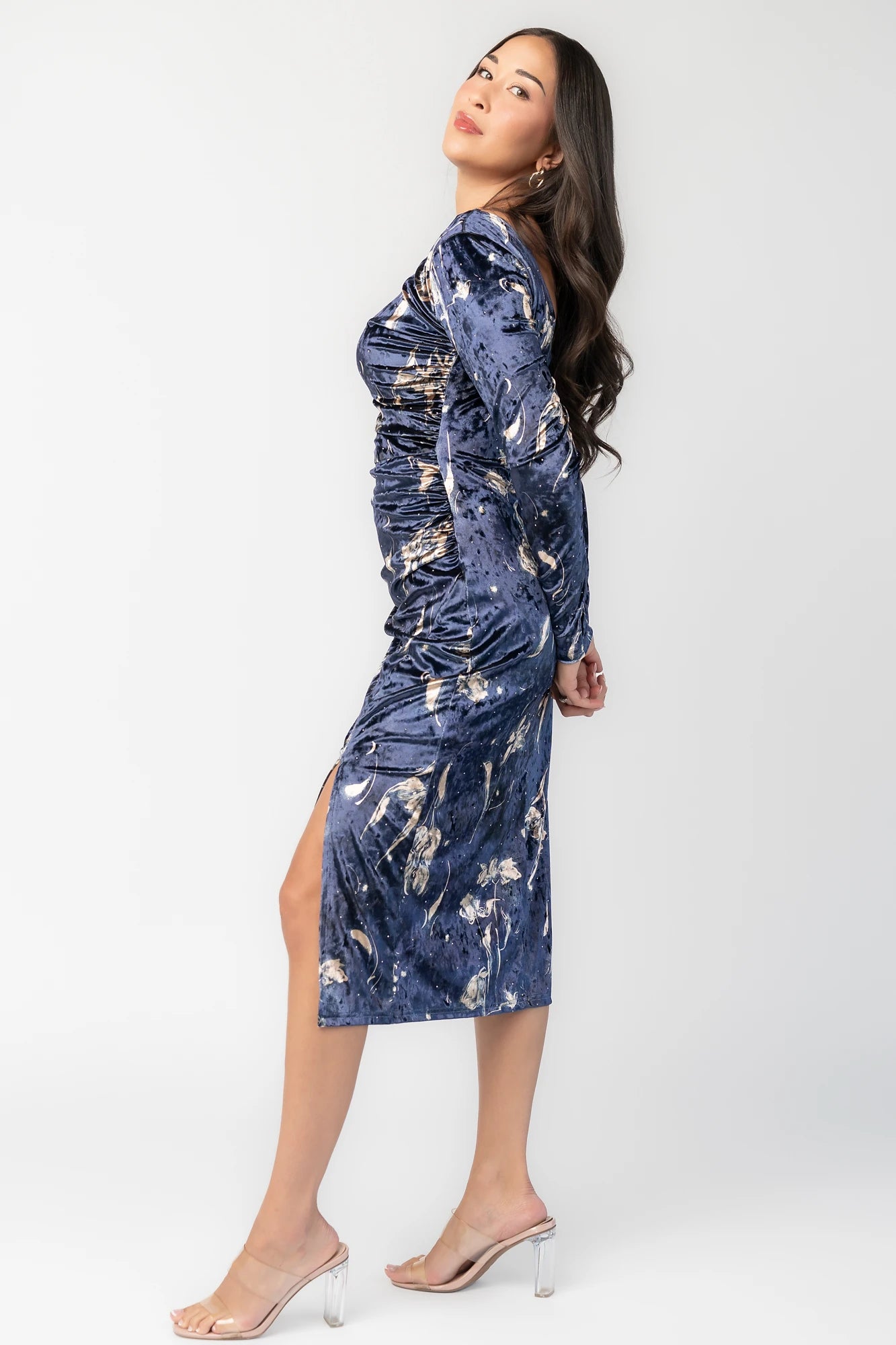 Afterglow Velvet Midi Dress in Navy + Gold with metallic florals, boat neckline, long sleeves, and side draping.