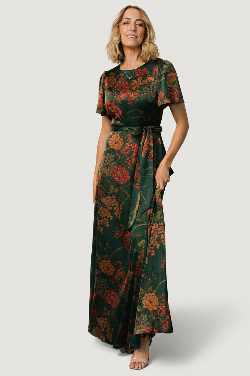 Back view of dark green floral satin maxi dress revealing keyhole button closure and elasticized back waist for fit.