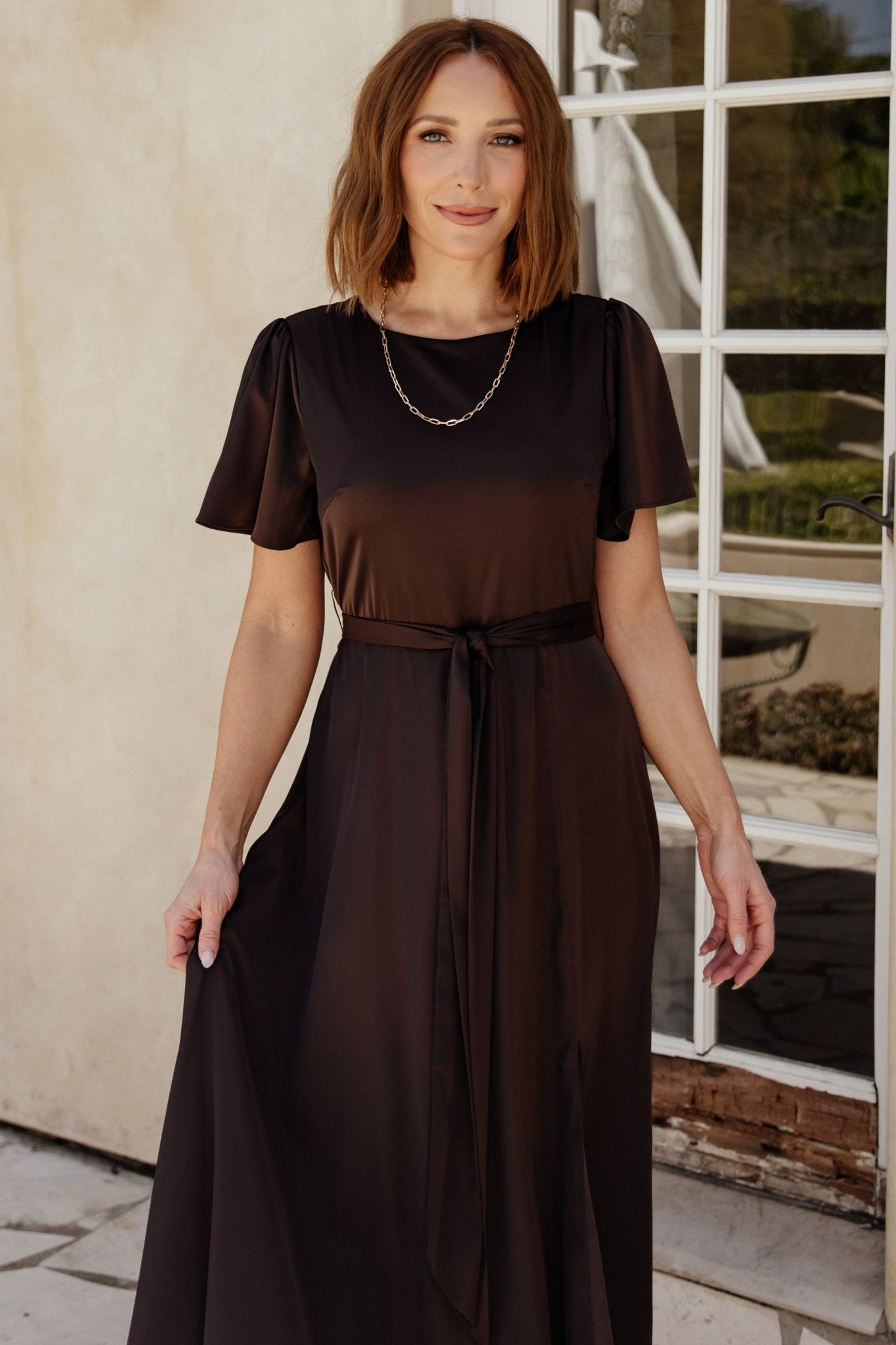 Detailed view of the Agnes dress fabric and stitching, highlighting satin sheen and the lined skirt for smooth coverage.