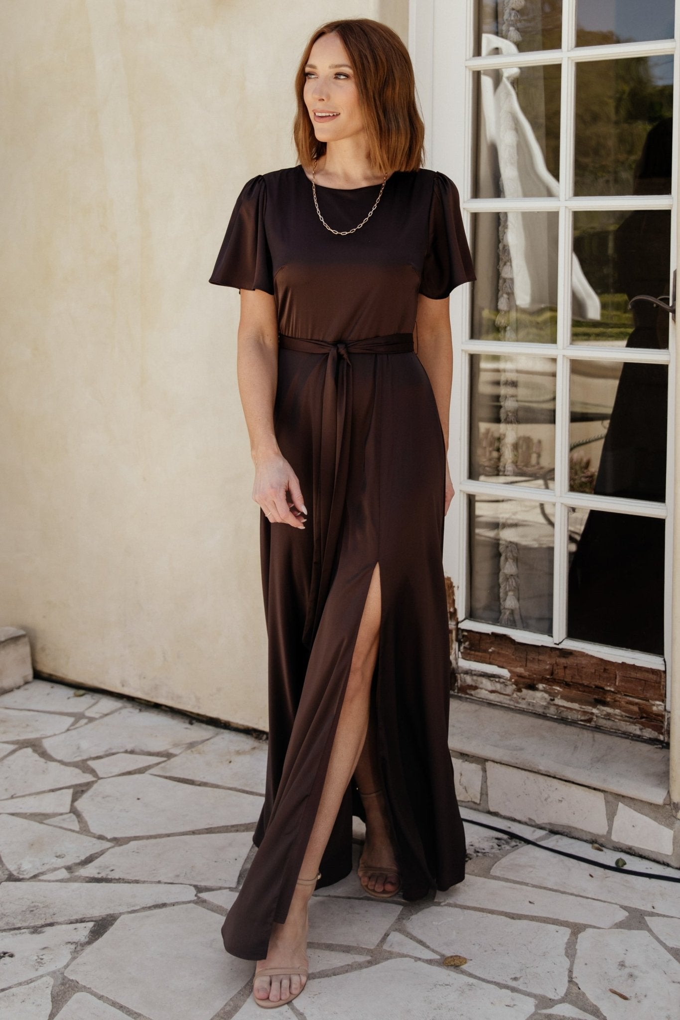Back view of the Agnes espresso satin maxi displaying the keyhole and button closure at the back neck and elastic back waist.