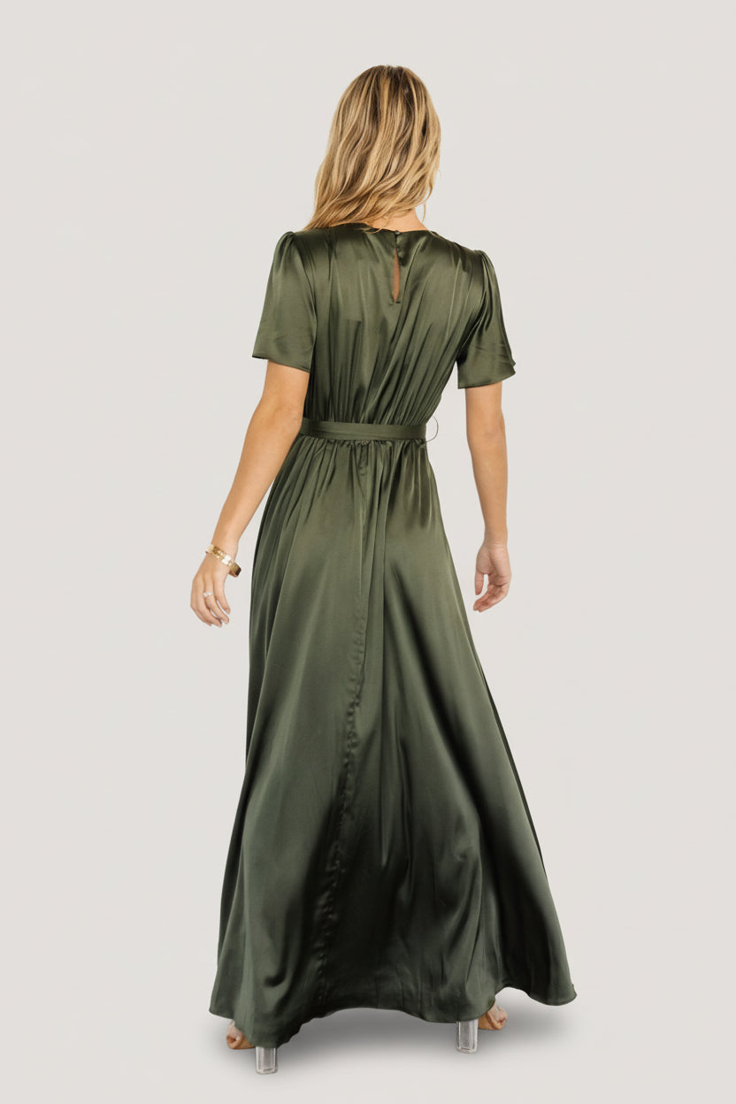 Back view of the Agnes satin maxi showing keyhole button closure, elastic back waist, and how the belt ties at the natural waist.