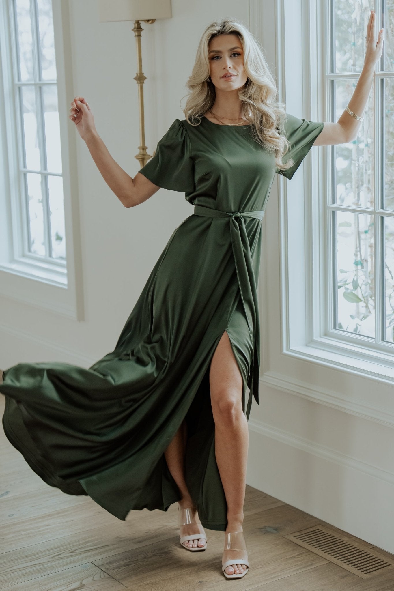 Image showing the left leg slit of the Agnes satin maxi dress as the model walks, capturing the skirt's sweep and movement.