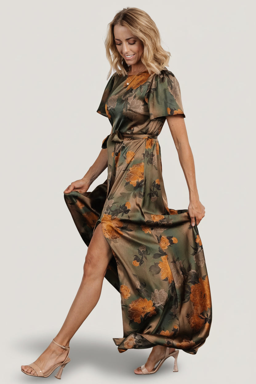 Detail shot of removable sash tied at natural waist and gentle gathers showing how the sash shapes the maxi silhouette.